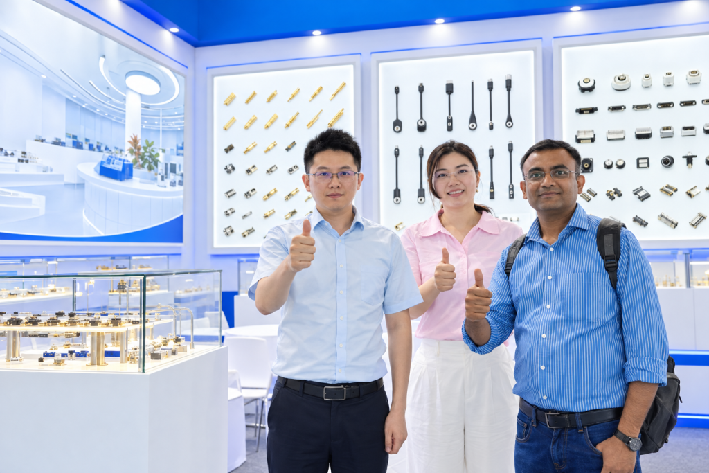 Exhibition visitors at a neutral connector display.