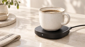 Mug on a round charging coaster in a neutral setting.