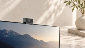 Compact webcam mounted on a monitor in a pale interior; application concept.
