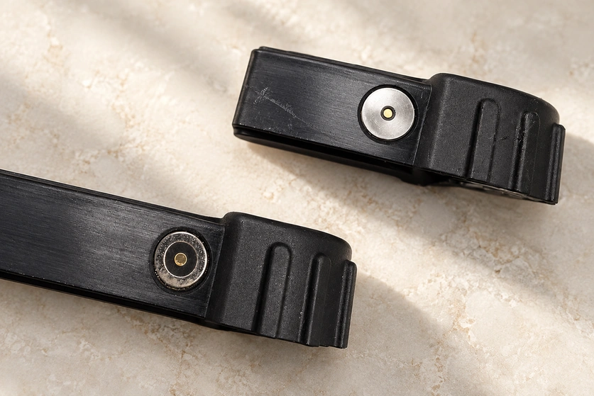 Circular central and ring contacts in two ribbed black housings.