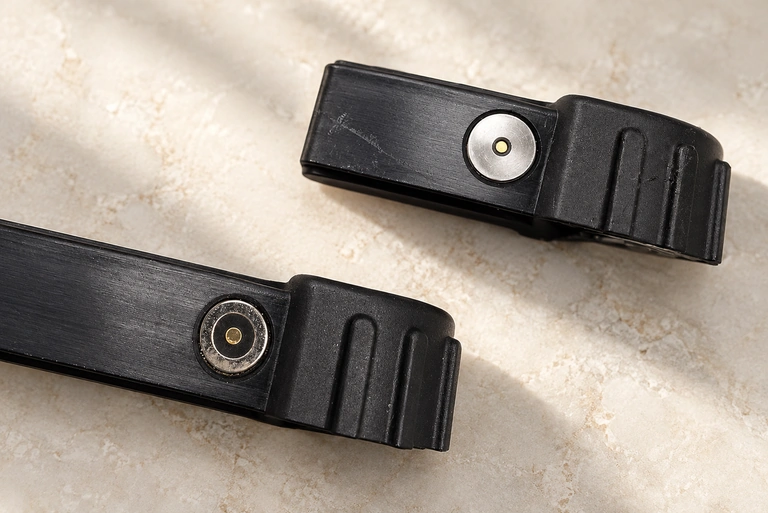 Circular central and ring contacts in two ribbed black housings.