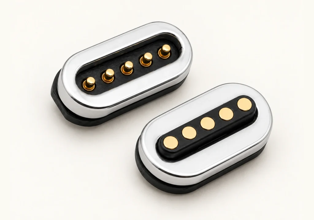 Five-contact silver capsule mating connectors with five raised pins and five flat pads.