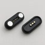 Three-contact black capsule mating connectors with circular end magnets on the pin half.